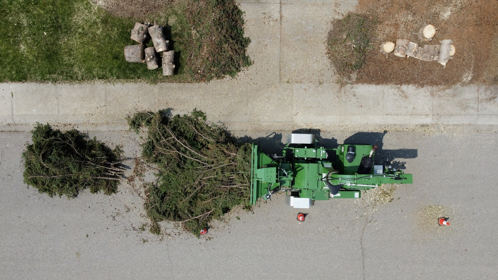 A wood chipper processing tree limbs at a job site