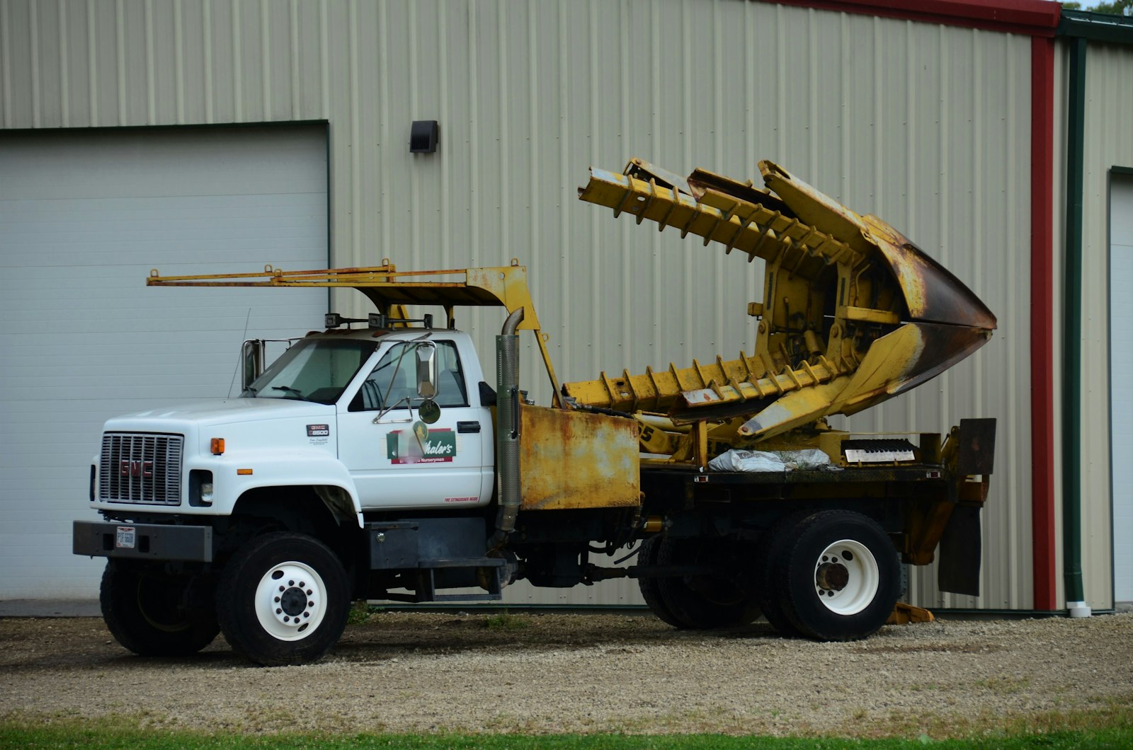 A work truck with a crane at a tree job